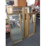 Four gilt framed hall mirrors