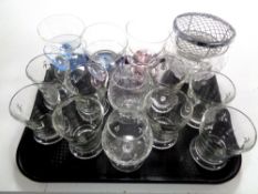 A tray containing assorted drinking glasses, glass dessert bowls,