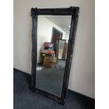 A Victorian style black framed bevelled edge overmantel mirror