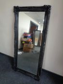 A Victorian style black framed bevelled edge overmantel mirror