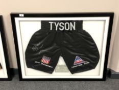 A sporting memorabilia montage : A signed pair of boxing shorts, Mike Tyson 'Kid Dynamite',