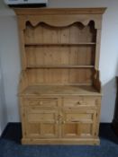 A stripped pine welsh dresser fitted double door cupboard and two drawers beneath