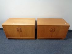A pair of 20th century teak double door low cupboards