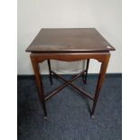 A square Edwardian occasional table on club feet