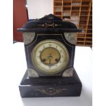 A late 19th century black slate and marble mantel clock with brass and enamelled dial