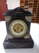 A late 19th century black slate and marble mantel clock with brass and enamelled dial