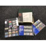 A box containing Royal Mail first day covers and Hectors packs British Mint stamps
