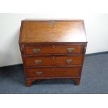 A 19th century oak and mahogany writing bureau fitted three drawers beneath