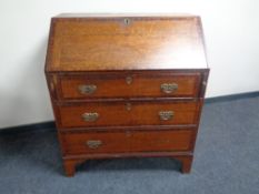 A 19th century oak and mahogany writing bureau fitted three drawers beneath