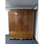 A late Victorian mahogany triple door wardrobe fitted two drawers beneath