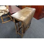 An Edwardian oak gate leg table