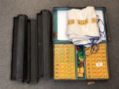 A cased Mahjong set with instructions and stands