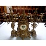 A three piece French gilt metal clock garniture
