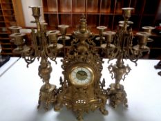 A three piece French gilt metal clock garniture