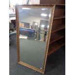 A gilt framed bevel edged overmantel mirror