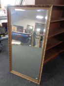 A gilt framed bevel edged overmantel mirror