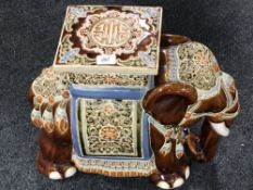 A glazed pottery elephant plant stand