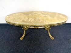 A gilt brass and onyx topped oval coffee table