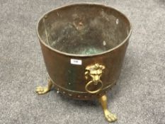 A nineteenth century copper coal bucket on lion paw feet