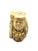 A carved Chinese bone netsuke - Gentleman holding a staff with basket