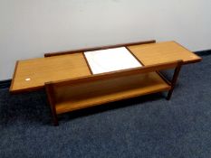 A 20th century teak extending coffee table with undershelf