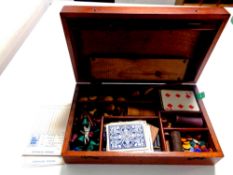 An Edwardian mahogany games box containing drafts, counters, cards, wooden cribbage board