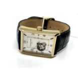 A Gentleman's Earnshaw gold plated wrist watch on black leather strap