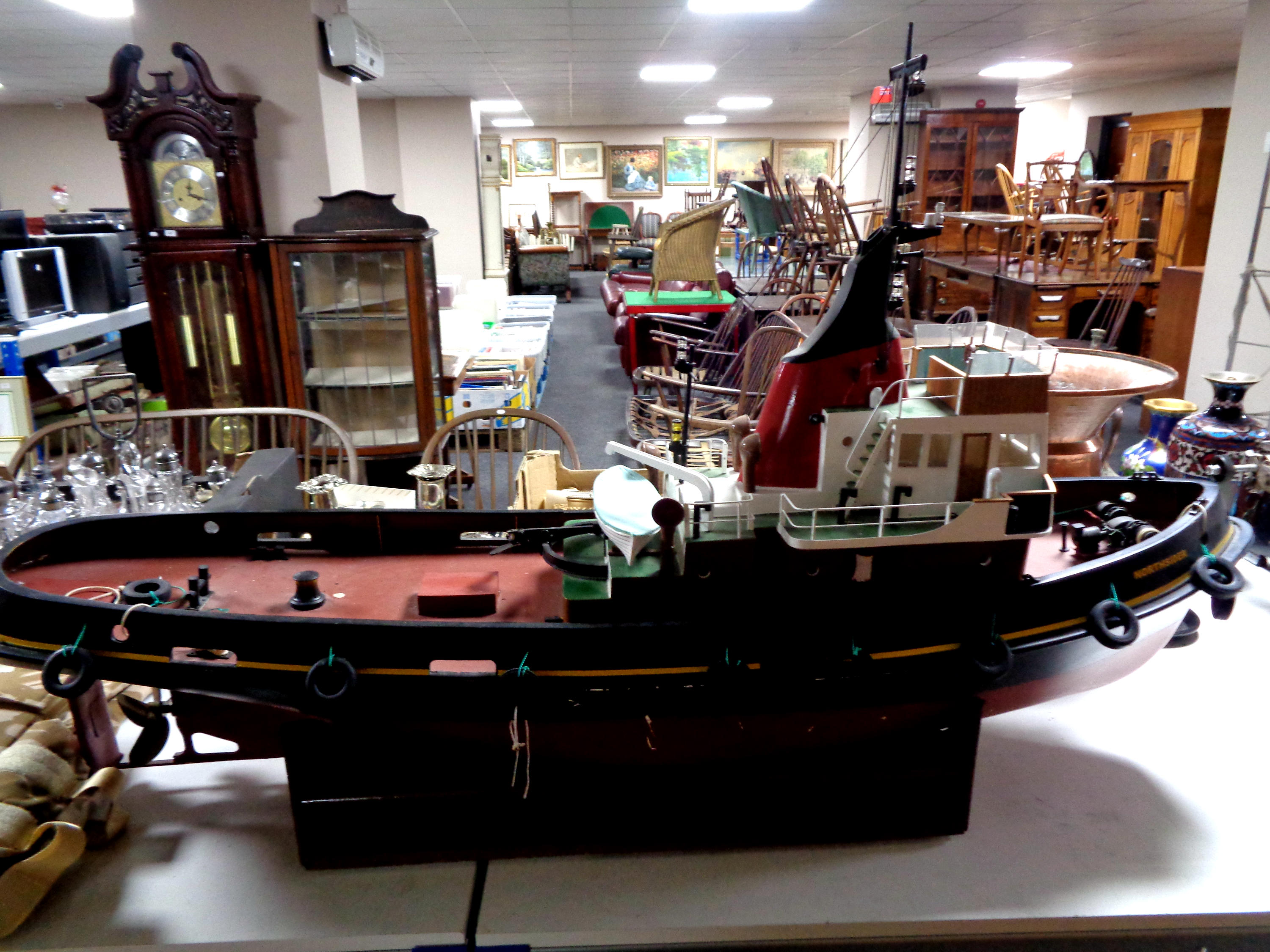 A wooden model of a fishing trawler on stand,