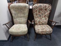 A pair of Ercol stained elm spindle back high back armchairs