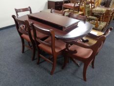A reproduction extending dining table together with a set of six chairs