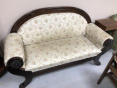 A Continental hall settee on lion paw feet with floral upholstery