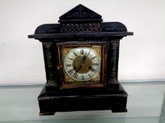A late Victorian stained wooden mantel clock with brass and silver dial