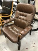 A twentieth century Continental beech framed brown leather upholstered armchair