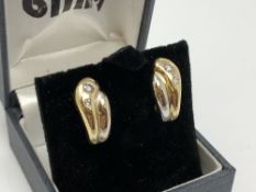 A pair of 18ct yellow and white gold diamond set earrings CONDITION REPORT: 7.