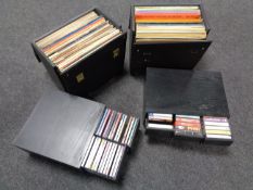 Four storage boxes containing a quantity of CDs and cassette tapes together with two further boxes