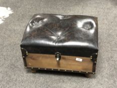 A buttoned leather storage footstool