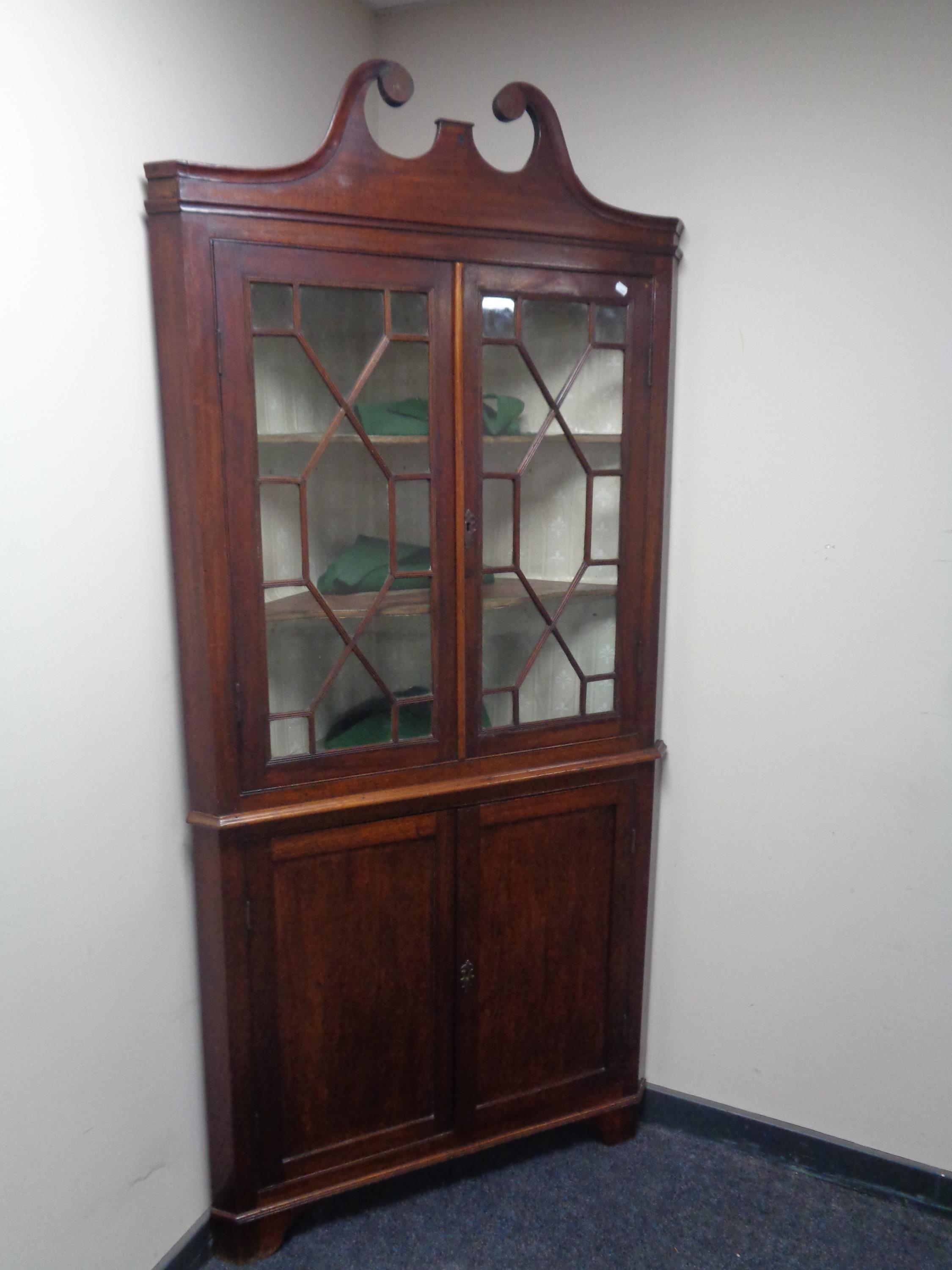A 19th century double door mahogany corner cabinet fitted cupboards beneath