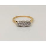 An 18ct gold and platinum three stone diamond ring, centre stone approx. 0.