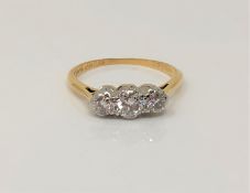 An 18ct gold and platinum three stone diamond ring, centre stone approx. 0.