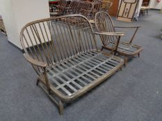 An Ercol spindle backed easy chair together with matching two seater settee (both lack cushions)