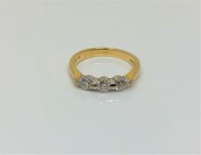 An 18ct gold three stone diamond ring, size K1/2 CONDITION REPORT: 3.