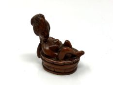 A carved Chinese hardwood erotic netsuke - nude bathing
