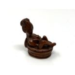 A carved Chinese hardwood erotic netsuke - nude bathing