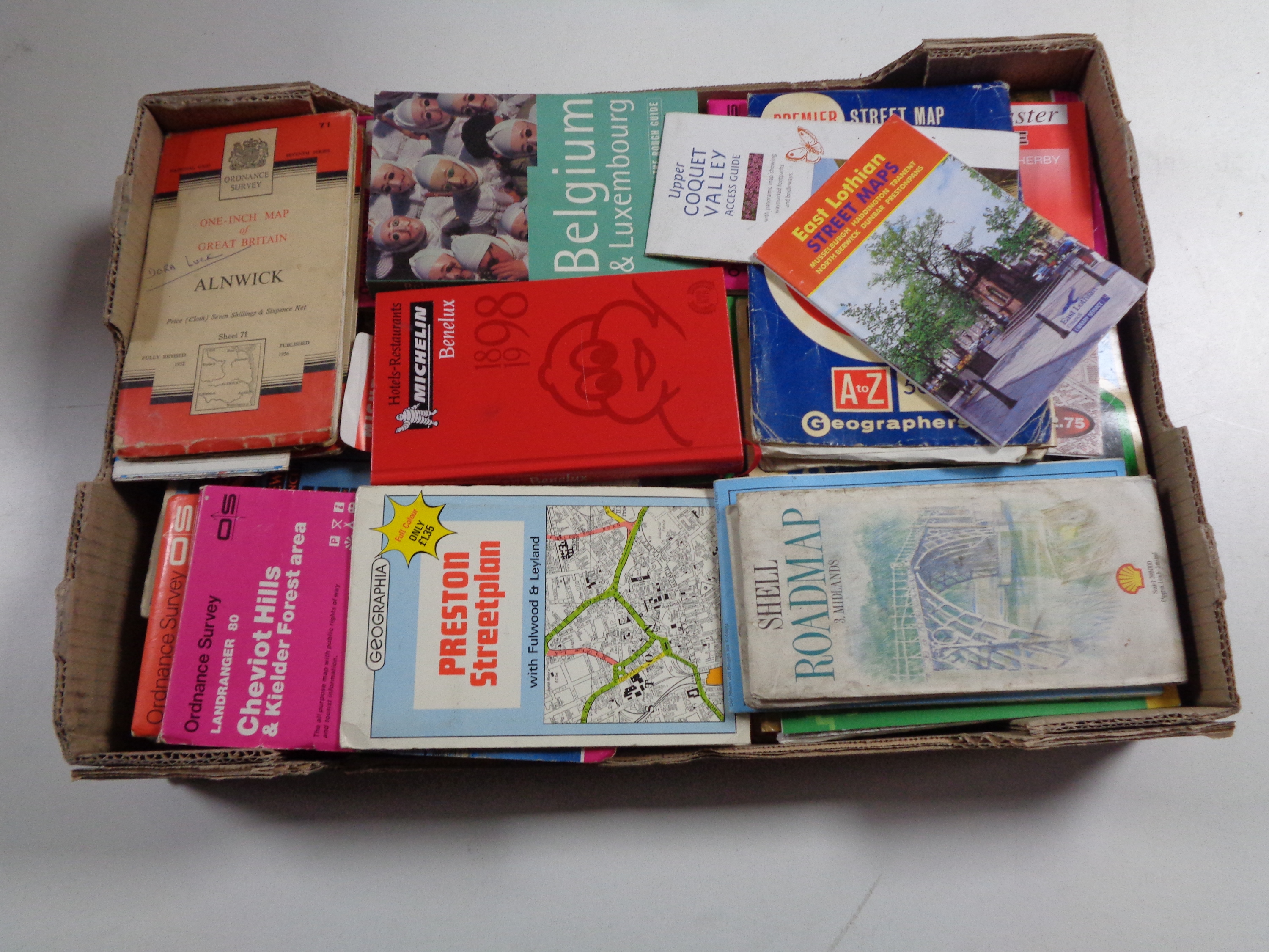 A box of Ordnance Survey and other road maps and guides