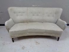 A twentieth century Continental three seater settee in buttoned upholstery