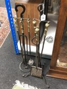 Two cast iron and brass fire companion sets