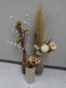 Three contemporary vases containing dried flowers