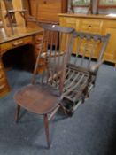 An Ercol carved back armchair (lacks cushion) together with a high back spindle dining chair (2)