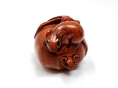 A carved Chinese hardwood netsuke - Two rats on fruit