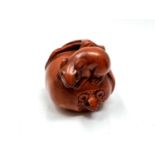 A carved Chinese hardwood netsuke - Two rats on fruit